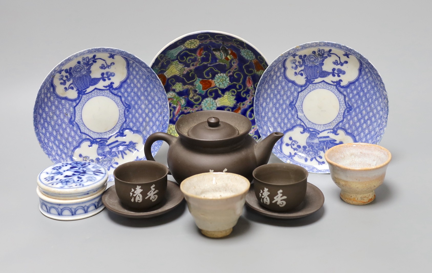 A selection of Oriental items, to include blue and white Japanese saucers, two stoneware tea bowls, a Chinese blue and white paste box and cover, and a Yixing teapot and a pair of tea bowls